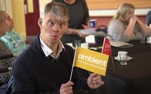 One of our Learning Disability service users waves an Ambient flag at the Grantham Get Connected event